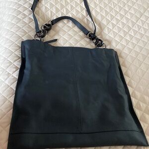 Black, multi purpose purse.  Can be worn as cross body or shoulder bag